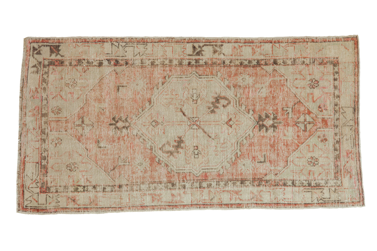 Distressed vintage Oushak runner, faded dusty rose and antique ivory geometric medallion, 2'5" x 4'11".