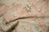 Vintage Distressed Oushak rug texture detail with worn pile and faded dusty rose tones.