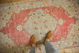 The soft, faded palette of a distressed vintage Turkish Oushak rug underfoot.