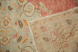 Detail of the vintage Oushak rug's hand-knotted reverse and its low, distressed pile.