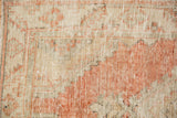 Visible wear to foundation and knot heads on a distressed Oushak in cantaloupe and beige.