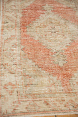 Low, distressed pile of a vintage Oushak rug showing wear down to the knot heads.