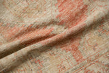 Soft folds reveal the time-softened, low pile and knot heads of a vintage Oushak rug.