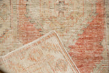 The hand-knotted foundation and secured side cord of a vintage distressed Oushak rug's corner.