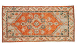Distressed Oushak runner with a stepped rust medallion and geometric floral details in powder blue and ivory.