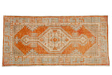 Vintage distressed Oushak rug runner with a hexagonal medallion in pale rust, powder blue, and ivory.