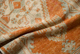 Angled view of a distressed Oushak rug, highlighting the texture of its low pile and knot heads.