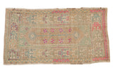 Vintage distressed Oushak rug with a central lozenge in faded mint green, beige, and bright fuchsia accents.