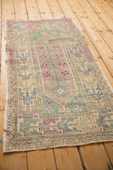 Overhead view of the hand-knotted Oushak rug, detailing its mostly even, low-pile wear.