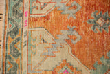 Textured distressed Oushak runner border, primitive arabesque design in rust, seafoam, and magenta.