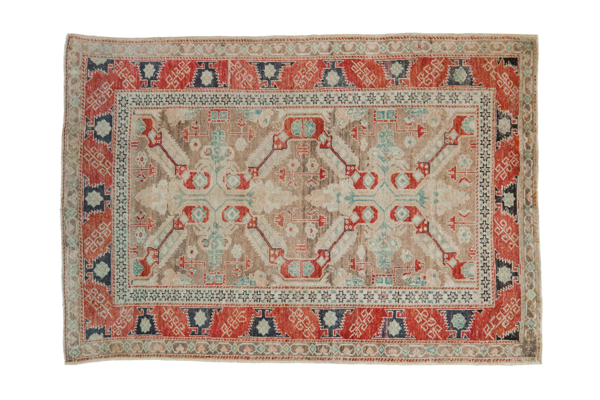 Distressed Anatolian rug with a double medallion in red, navy, brown and faded turquoise.
