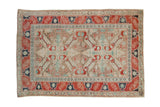 Distressed Anatolian rug with a double medallion in red, navy, brown and faded turquoise.