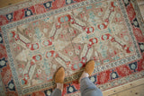 The full scale of a distressed Anatolian rug showing its worn texture and geometric pattern.