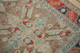 Angled detail of a vintage Anatolian rug showing wear to the knot heads and geometric borders.