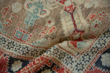 The distressed low pile and starburst border in faded turquoise, red, and coffee brown tones.