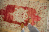 Perspective view of a distressed Anatolian rug highlighting the scale and heavily abrashed red pile.