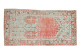 Distressed Oushak runner with a dual-panel prayer design in faded red, seafoam, and brown tones.
