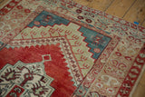Geometric stepped medallion and floral borders on a vintage distressed Anatolian rug corner.