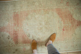 Low pile with visible knot heads on a distressed Oushak showing time-softened dusty rose hues.