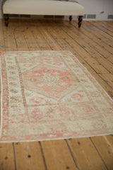 Distressed pile of the vintage Oushak runner with soft blush, ivory, and coffee brown floral designs.