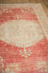 Angled perspective showing the textural, distressed low pile on a vintage Oushak rug.