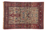Antique Isfahan rug with a pictorial Tree of Life motif, birds, and a red faunal border on an ivory ground.