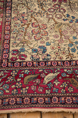 Detailed view of pictorial birds and the red floral border on a fine antique Isfahan rug.