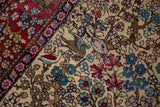 Detail of two perched birds feeding amidst blossoms on an antique Persian Tree of Life rug.