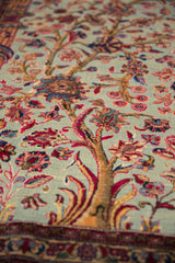 Finely delineated antique silk Tree of Life motif with cochineal red palmettes on jade green.