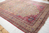 Antique silk Kashan rug border with intricate cochineal red, sapphire blue, and jade green field details.