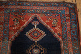 Antique Bijar runner detail: stepped hexagonal design in navy with hook-and-latch motifs and madder red field.