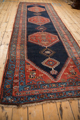 Antique Bijar rug end, madder red and dusty teal floral border, with fringe.
