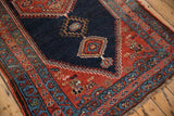Antique Bijar rug runner's madder red field, dusty teal meandering borders, and fringe.