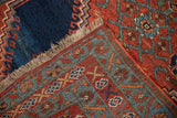 Hand-knotted foundation and robust pile of this antique Bijar runner, showing madder red and teal patterns.