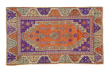 Vintage distressed Oushak rug with interconnected geometric columns in terracotta, aubergine, and sea foam green.