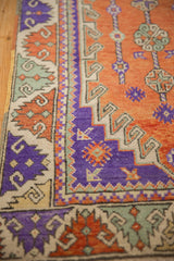 Stylized reciprocating border design in aubergine, terracotta, and dusty sea foam green.
