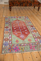 Vibrant floral border and lower tree of life motif on a distressed vintage Oushak runner.