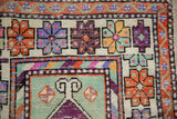 Distressed vintage Oushak runner close-up highlighting finned floral motifs and nuanced geometric borders.