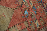Starburst floral motifs and sky blue faux-silk highlights on a distressed Oushak rug.