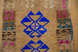 Lustrous cobalt blue gul medallion showing the worn, hand-knotted pile of a distressed Kars rug.