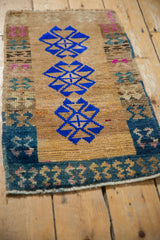 The dynamic, abrashed field of a distressed Kars rug mat, featuring a row of three geometric blue guls.