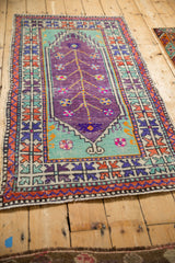 Distressed Oushak runner with a purple Tree of Life design, mint spandrels, and vibrant borders.