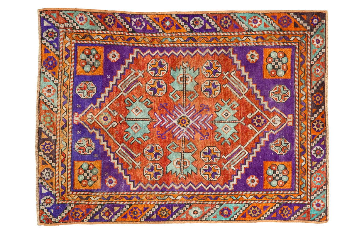 Vibrant distressed Oushak rug with central quatrefoil medallion, rust, violet, and mint hues. 2'10" x 3'9".
