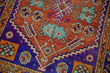 Distressed pile texture showing serrated white and faded turquoise quatrefoil motifs.