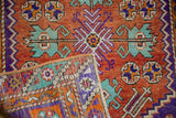 Vintage distressed Oushak rug's rust, purple, and turquoise geometric patterns alongside hand-knotted reverse.