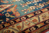 Close-up detail of the articulated floral motifs on the ivory border and powder blue field of a fine antique Kermanshah carpet.