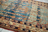 Fine Kork wool pile of an antique Kermanshah showing intricate floral rows and softly aged blue dyes.