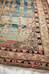 Fine knotting and floral arabesques in the corner of a 19th-century Kermanshah collector rug.