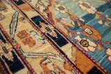 Detailed macro view of the fine, asymmetrical knots and silky Kork wool pile on a Qajar period Kermanshah carpet.