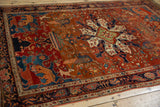 Deeply saturated vegetable dyes and folkloric animal motifs on an antique Persian Farahan Sarouk rug.